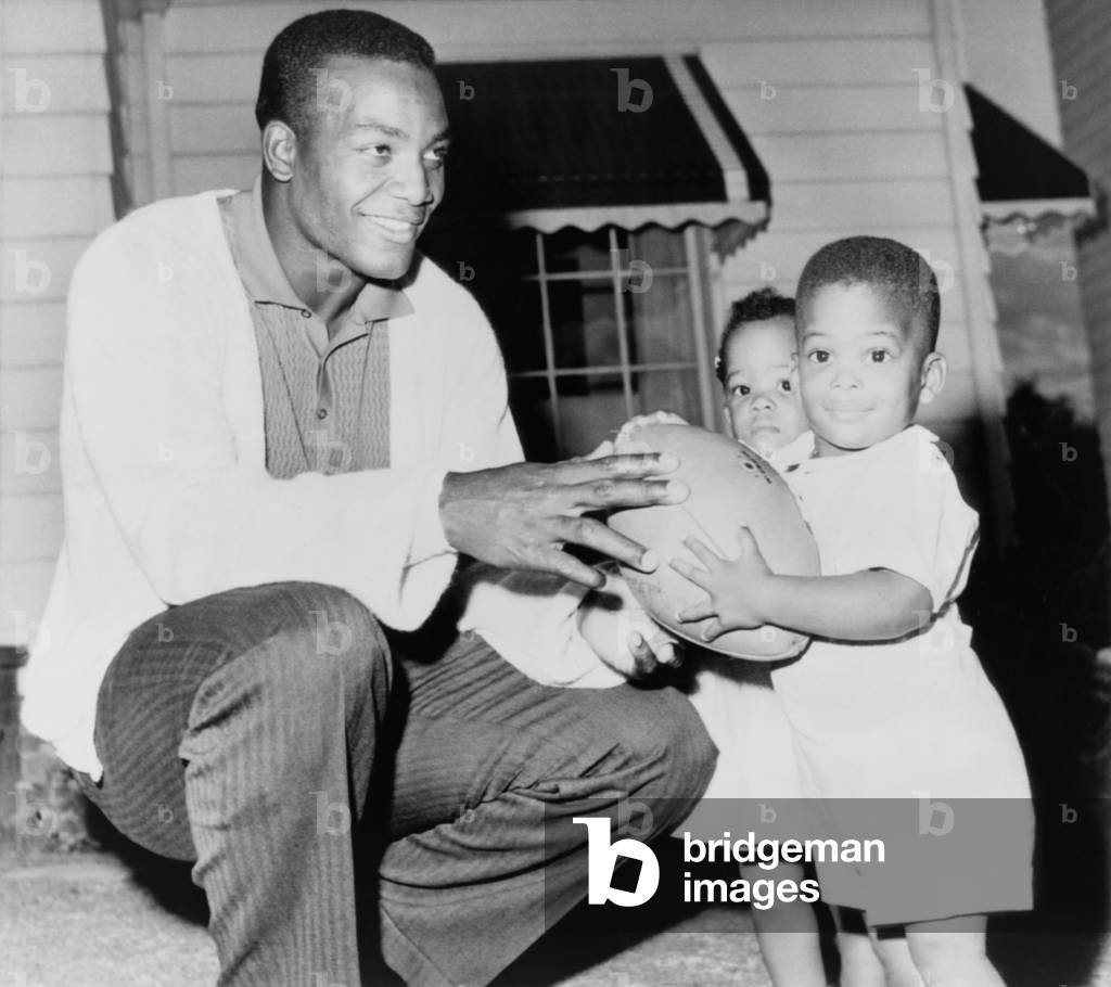 Jim Brown, at the beginning of his professional football career with his twins, Kevin and Kim. Sept. 27, 1961
