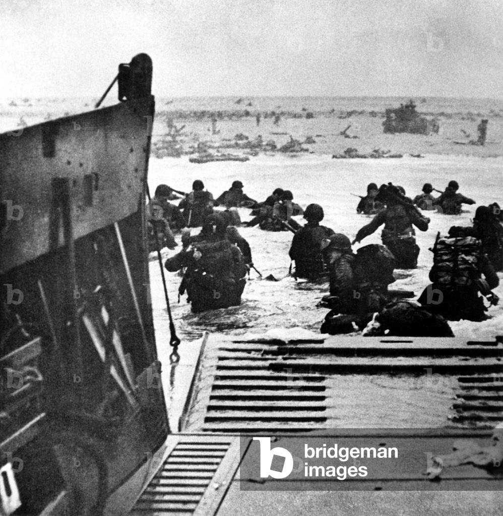 World War II: Led by amphibious tanks, British troops assault a beach.