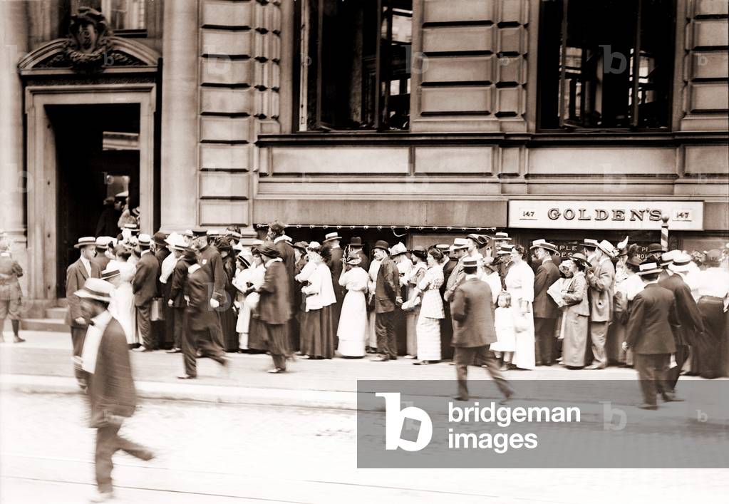 A long line of men and women line up in a run on the German American Bank of New York City. c. 1905-1915