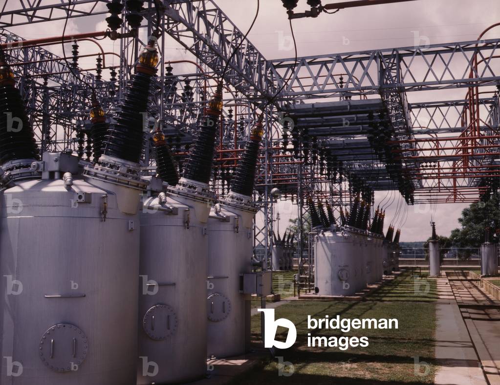 Switchyard at TVA's Wilson Dam hydroelectric plant, near Sheffield, Alabama. A series of electrical transformers topped with ceramic insulators, transfer power from the generation system of the Wilson Dam to the distribution system that delivered power to consumers. 1942