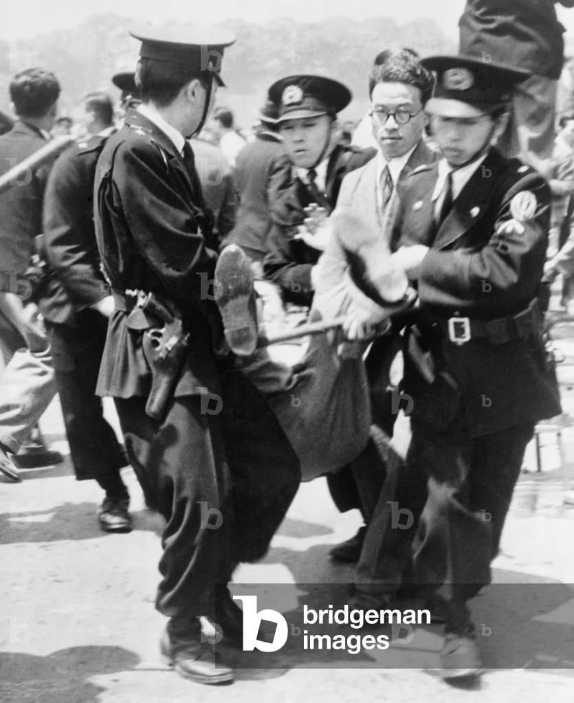 Japanese police hauling away a demonstrator during the 4th anniversary constitution day ceremony at the Imperial Palace plaza, Tokyo, Japan. 1951