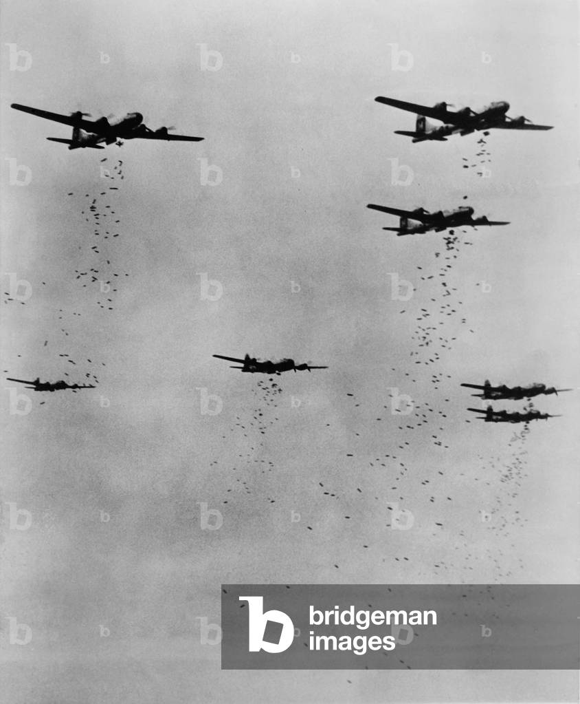 Formation of B-29's releasing incendiary bombs over Japan in June 1945. World War 2