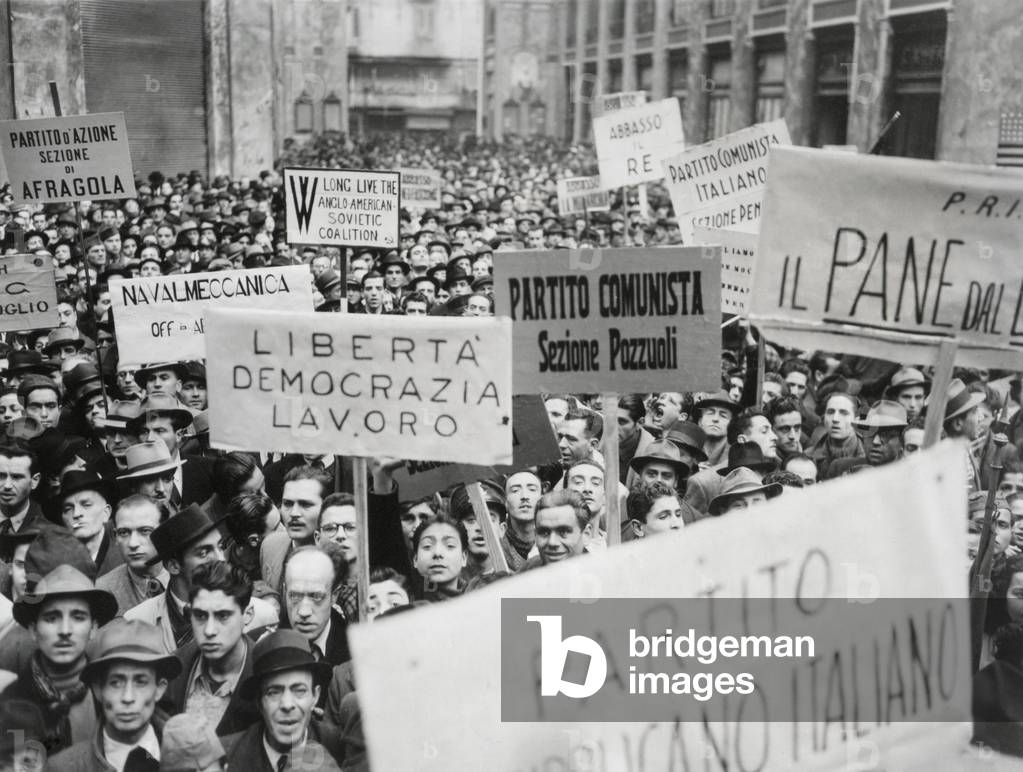 Italian men in Naples waved banners and signs as they demonstrated in Naples. Several are for Communist groups in the first open political expression after 22 years of Mussolini's Fascism. Dec. 3, 1944. World War 2