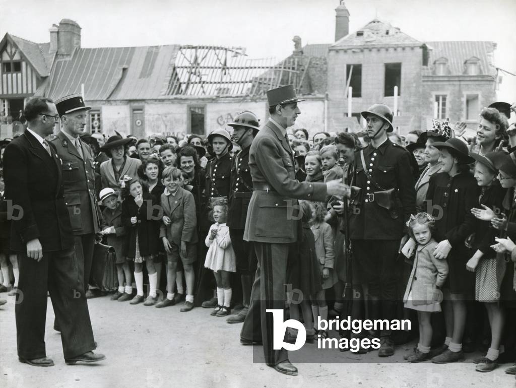 General Charles De Gaulle in Normandy, June 11, 1945. In the background are bombed out buildings. De Gaulle was Chairman of the Provisional Government of the French Republic.