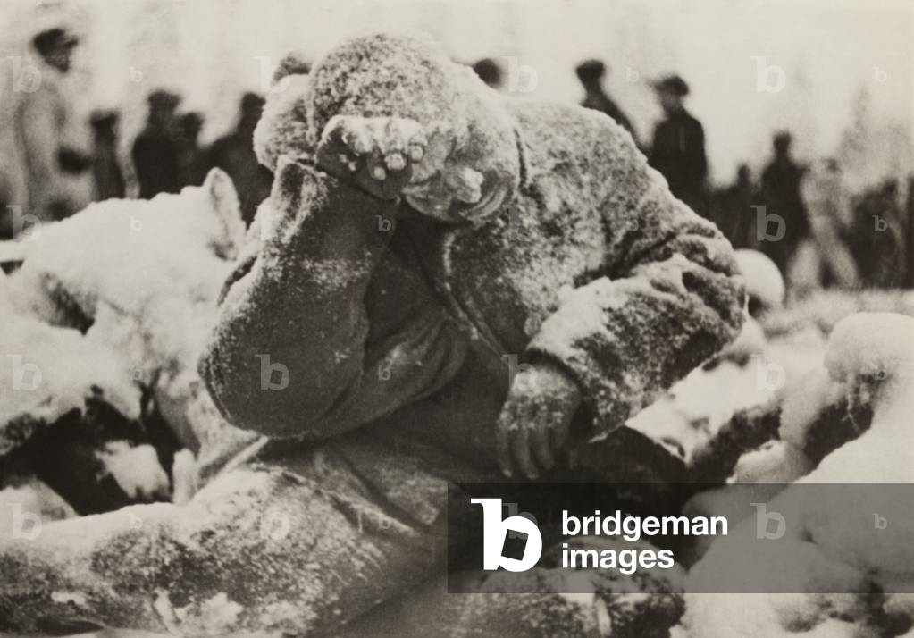 Dead Russian soldier sitting, covered with a dusting of snow, a casualty of the Battle of Suomussalmi, during the Russo-Finnish War of 1939-40