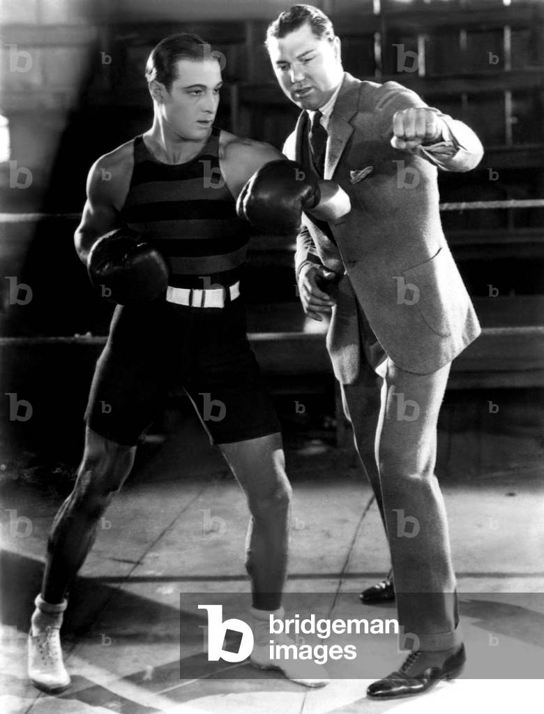 Ruldolph Valentino and heavyweight boxing champion Jack Dempsey at5 Valentino's studio in Hollywood. c. 1925
