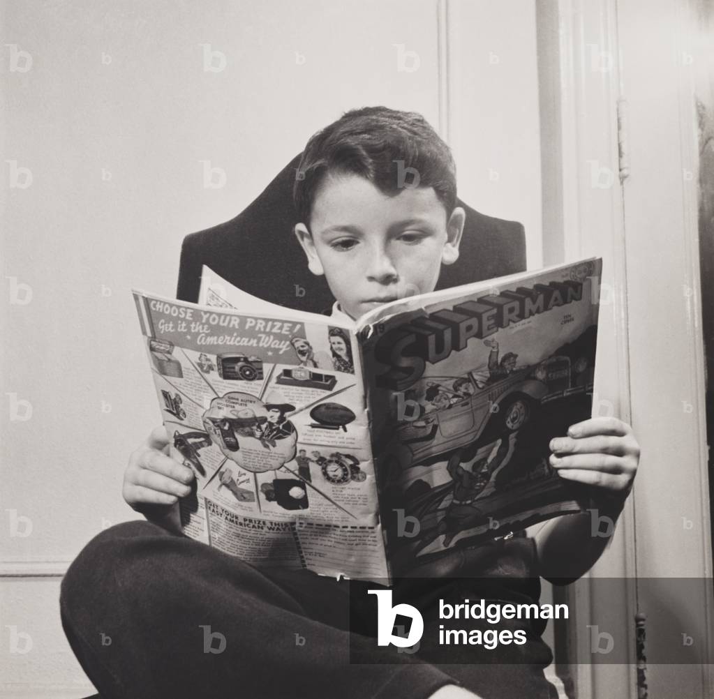 German refugee boy reading a Superman comic at the N.Y. Children's Colony school in 1942