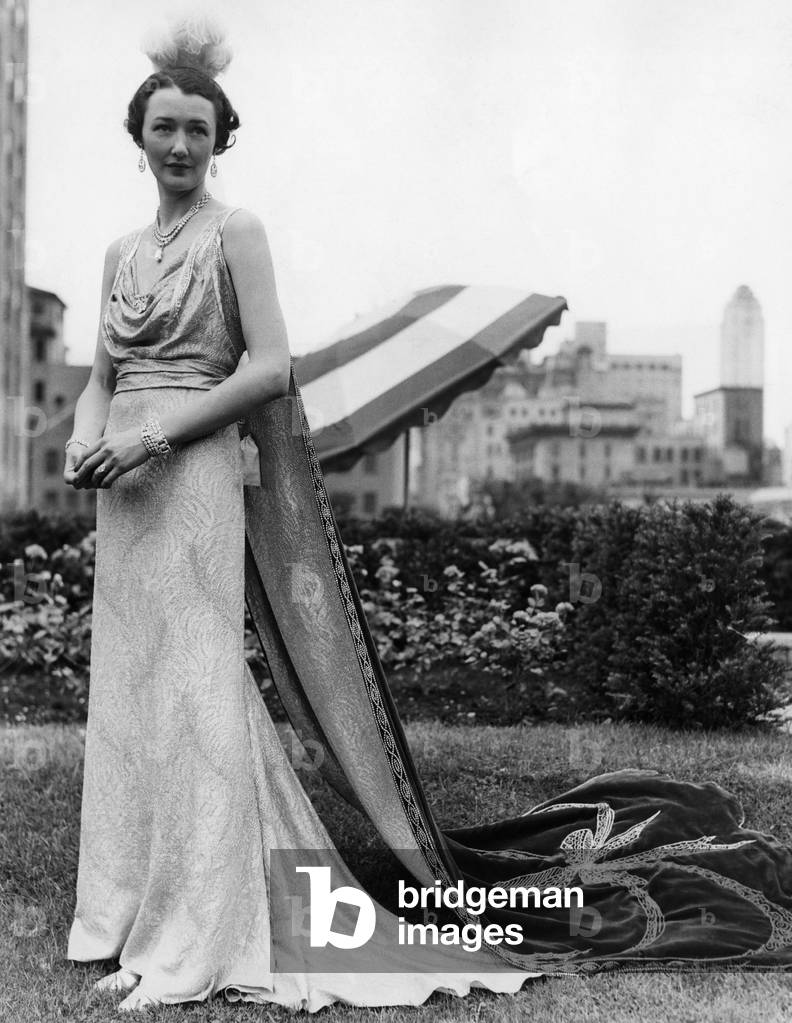 The official regulation court costume during the Coronation year of King Edward VIII, it is jewel blue and silver lame with crystal shoulder straps and ornaments. Gown by Reville, England, 1936