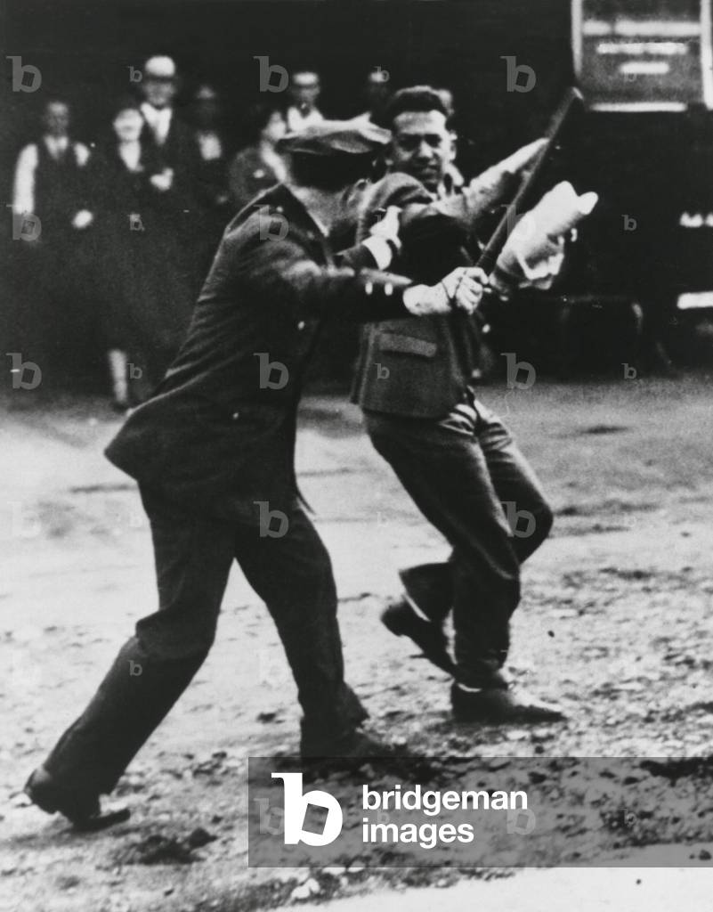 A striker dodges policeman's night stick during San Francisco General Strikes. 1934. The West Coast waterfront strike lasted from May 9, 1934 to July 17, 1934, affecting the ports of San Francisco and Oakland, California, Portland, Oregon and Seattle, Washington