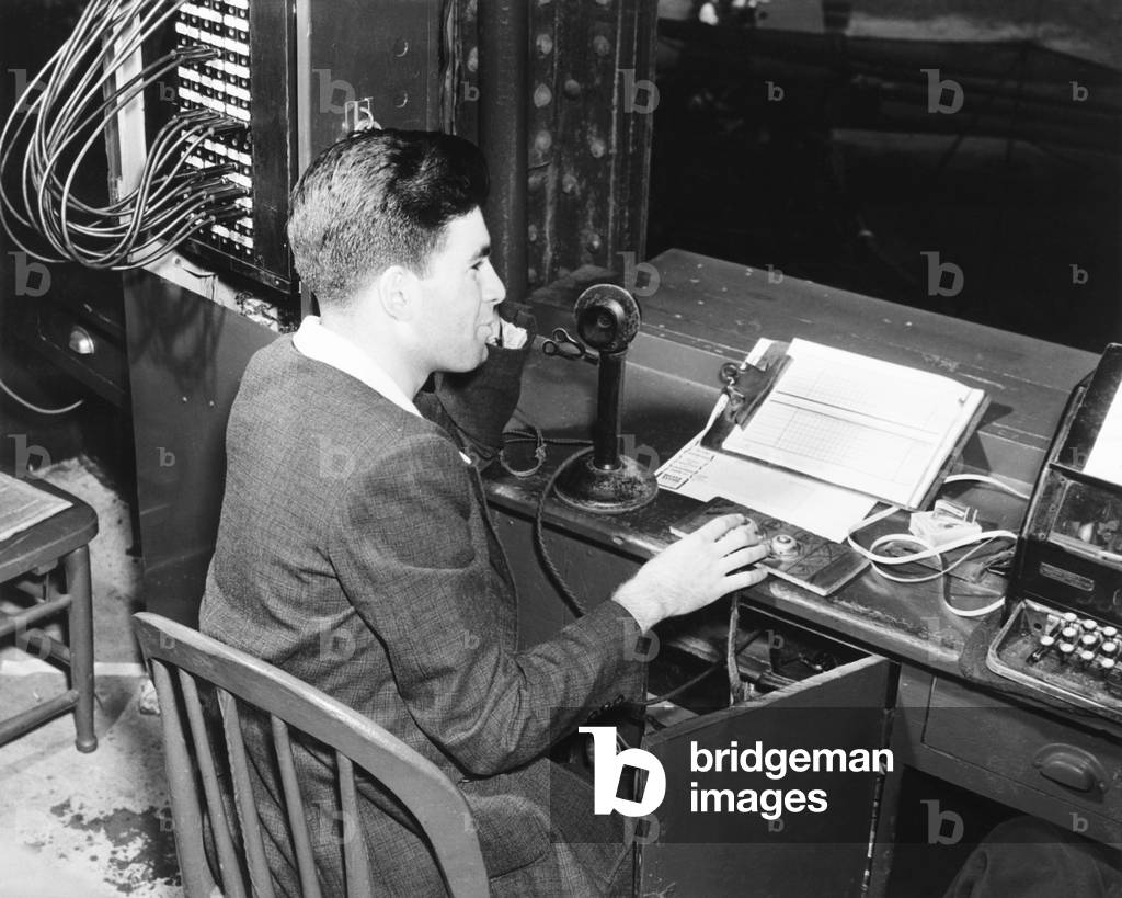 Yankee Stadium scoreboard is controlled by Gus 'Little Abner'. He uses the telephone to talk directly with workers who manually change at the scoreboard. Sept. 20, 1939