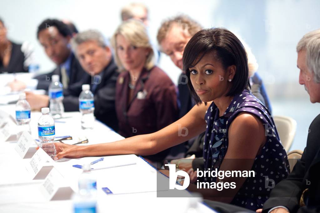 Michelle Obama attends a meeting with Communities In Schools board members at the Ferebee-Hope Elementary School in Washington D.C. May 13 2009. Michelle wears a dark blue and white dotted dress by Lanvin.,
