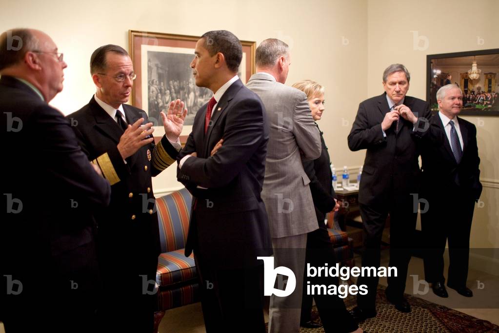 President Obama talks with Admiral Michael Mullen prior to a speech on Afghanistan and Pakistan. March 27 2009. In the background are Jim Jones Hillary Clinton Richard Holbrooke and Robert Gates. (BSWH_2011_8_239)
