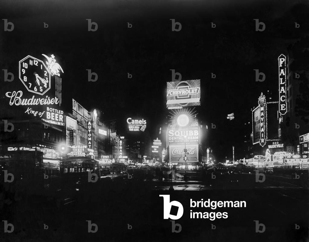Times Square north at night, New York City, Jan. 1934. Lighted signs advertise theaters, Burlesque and Vaudeville houses, and famous brand consumer products