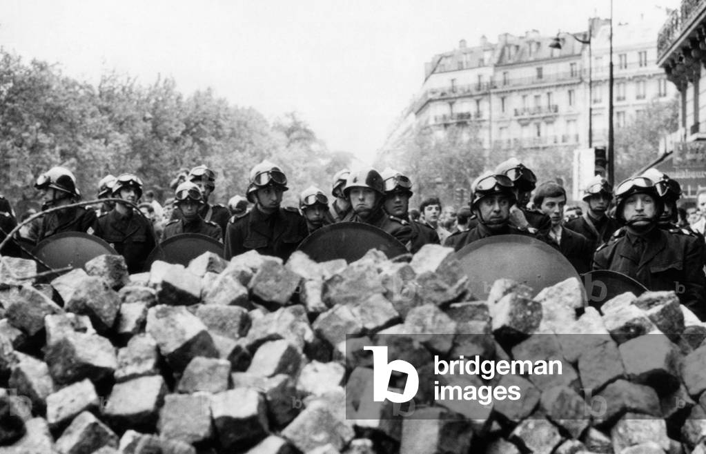 Police behind a barricade made of stones by rioting students in the Latin Quarter of Paris, France, 1960s.