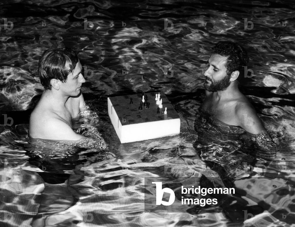 Bobby Fischer plays a chess match with Larry Evans in a indoor pool at the Grossinger Hotel in the Catskills, New York. c. 1971