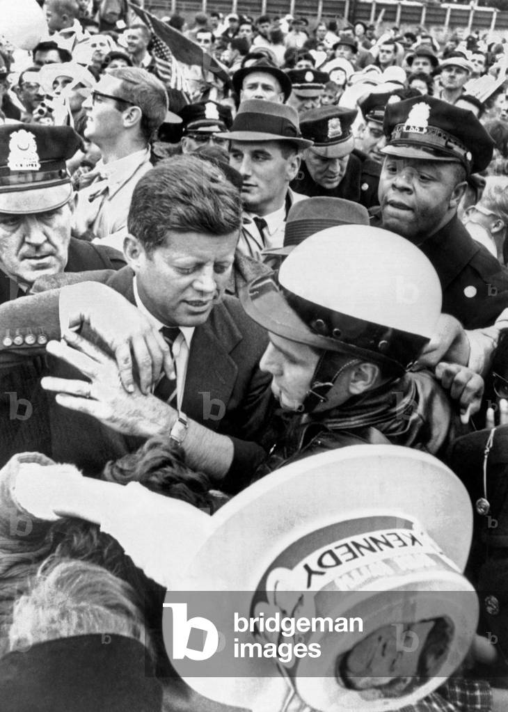 Democratic Presidential nominee John Kennedy campaigning. Police help him to his car through a crowd of supporters in Willow, Grove, Pennsylvania. Oct. 29, 1960