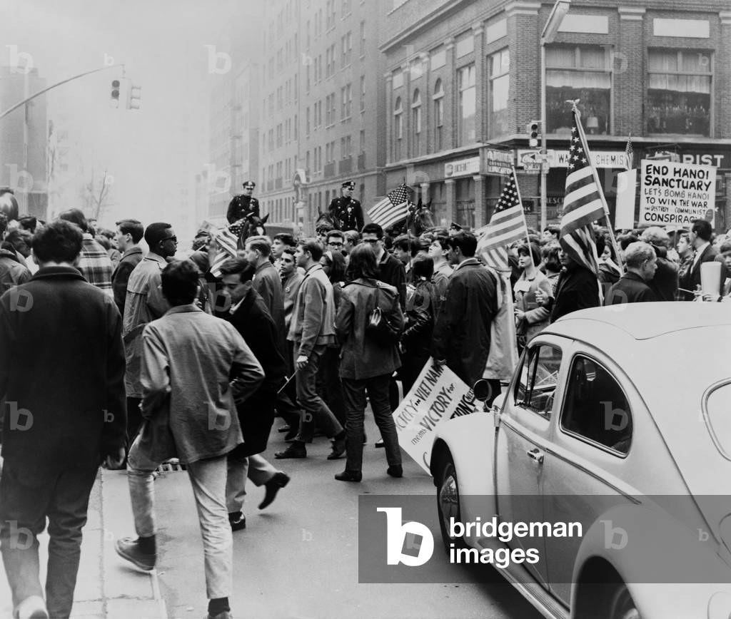 Pro-Vietnam War demonstrators. Counter-demonstrators, marching on New York City's Third Avenue with: Pro-Vietnam War demonstrators. Counter-demonstrators, marching on New York City's Third Avenue with flags and placards supporting of the war in Vietnam. April 15, 1967. 