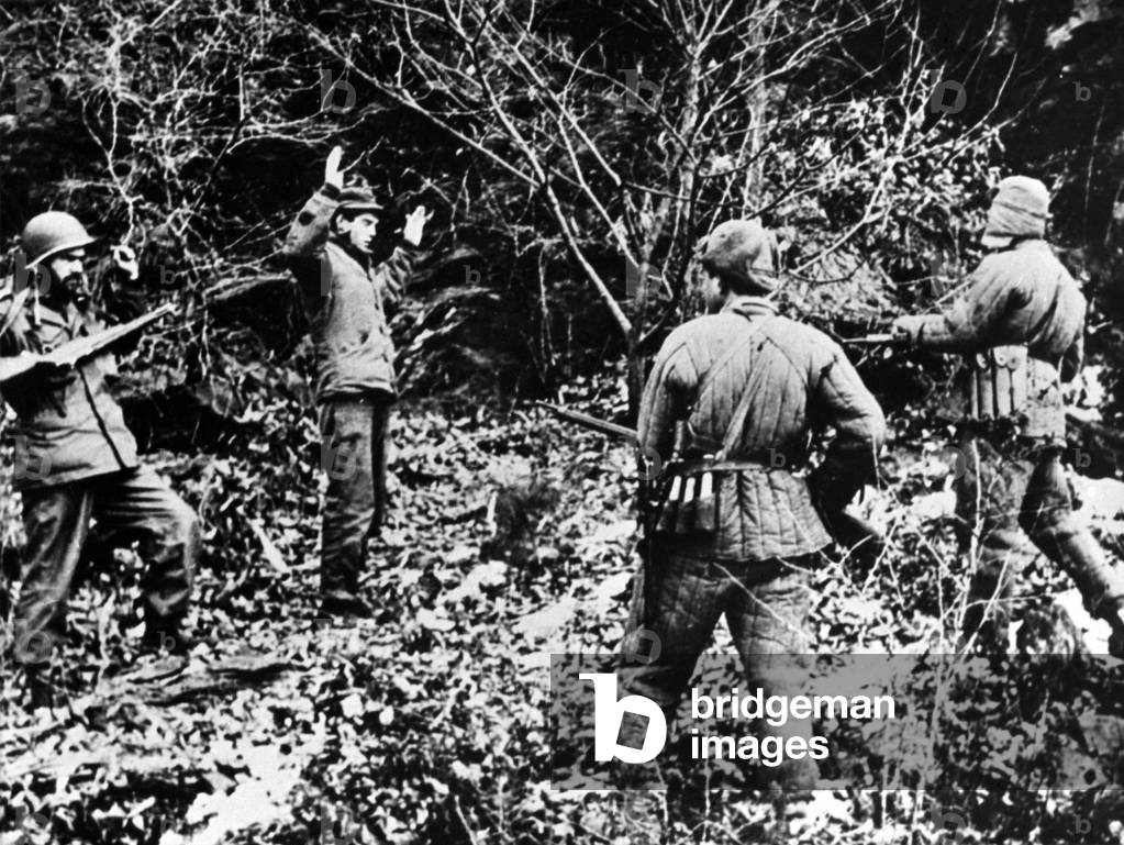 Two UN soldiers (probably U.S.) captured by North Korean soldiers. Probably in South Korea, c. July-Oct. 1950. Prisoners taken by North Koreans in the first six months of the war faced harsh, and often fatal, treatment from Koreans captors. Korean War, 1950-53