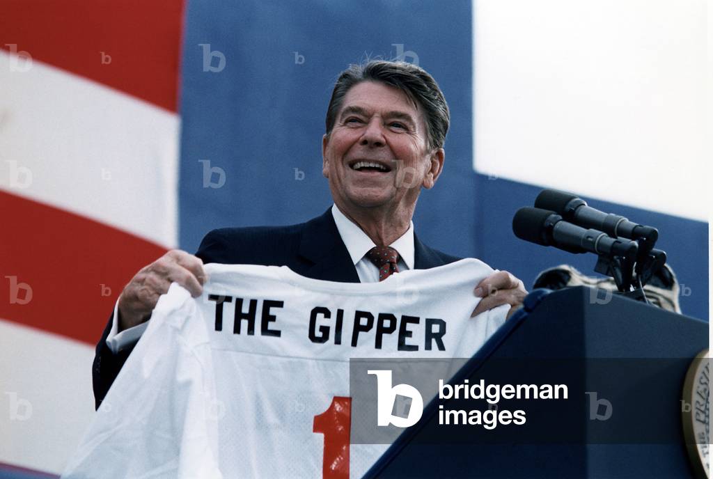 President Reagan holding a 'Gipper' jersey at a Reagan-Bush Rally in New York, 1984 (photo)