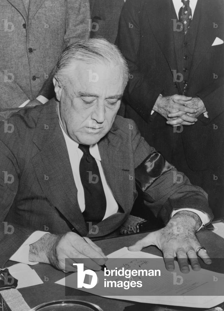President Roosevelt signs declaration of war on Japan on Dec. 8, 1941, the day following Japan's surprise attack on Pearl Harbor