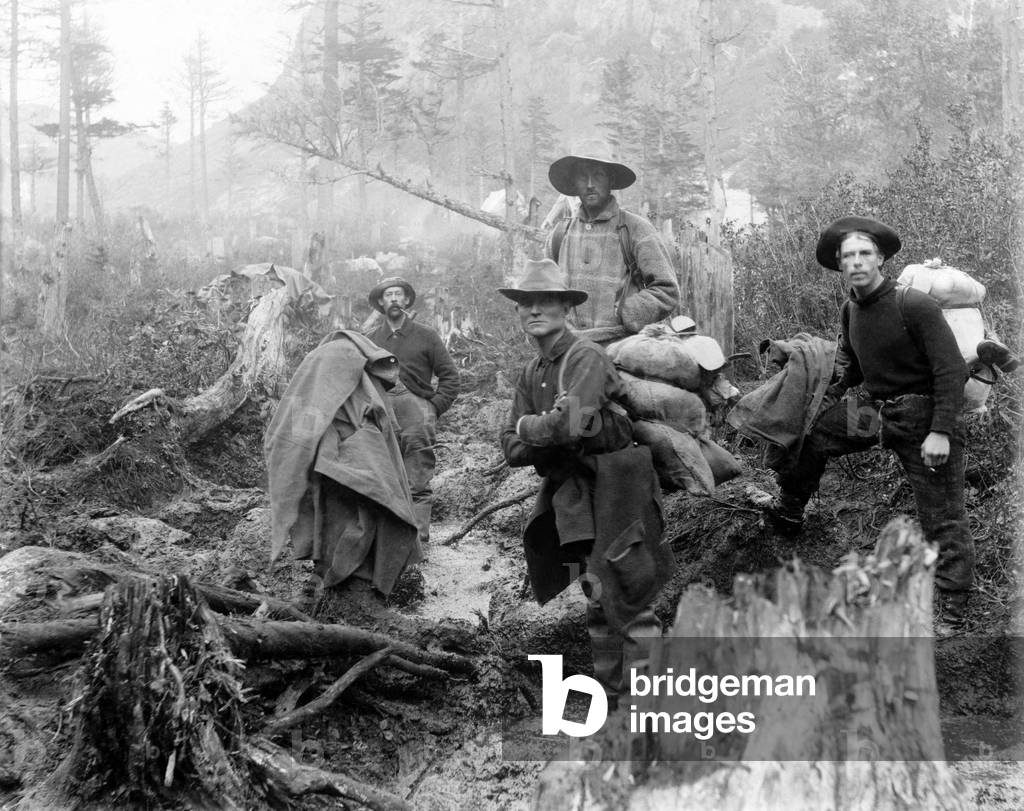 Four prospectors posed on trail in Alaska during the Yukon gold rush in 1897