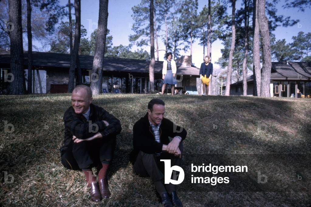 Mercury astronauts John Glenn and Scott Carpenter on the lawn outside of the Glenn's house. Their wives Annie Glenn (brunette) and Rene Cawrpenter (blonde) are behind them on the right. Ohio, 1965