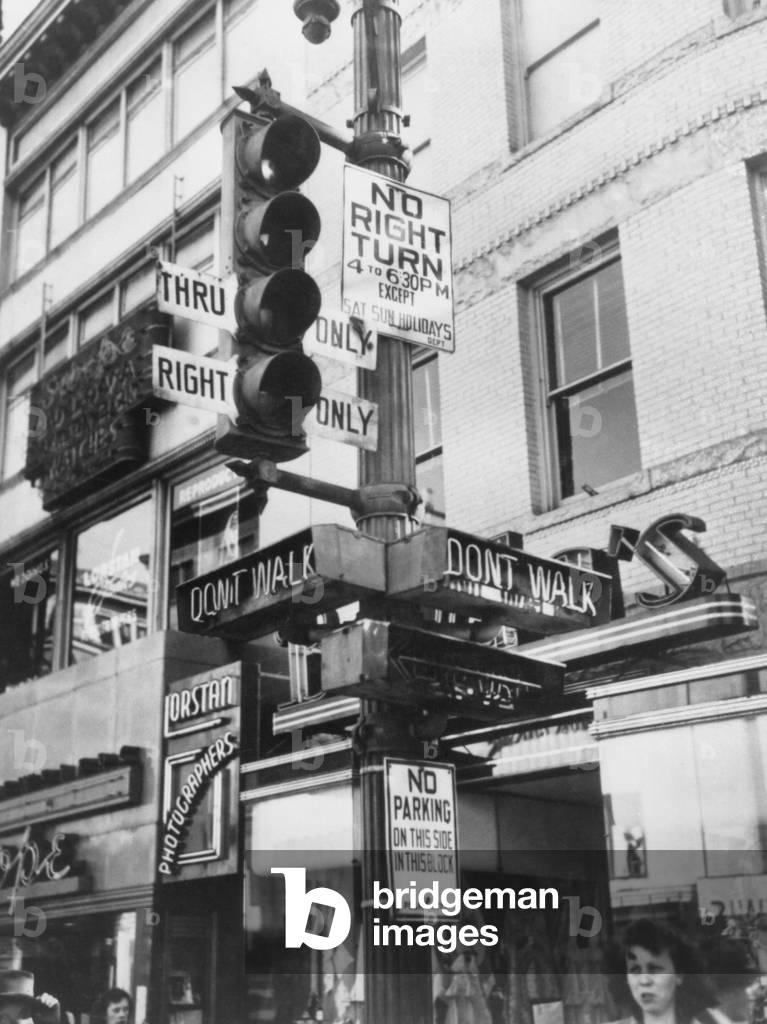 A complicated traffic signal to uncomplicate traffic in Washington, D.C. The 'Walk' and 'Don't Walk' signals help pedestrians safely cross the streets. 1949