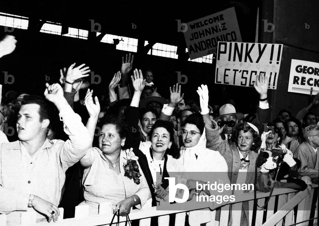 Families waving as they greet the troop ship of the POW's returning from the Korean War. August 23, 1953. Fort Mason, California. Korean War, 1950-53