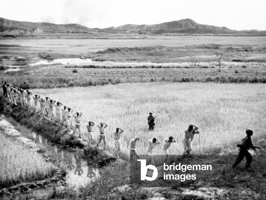 Korean War: U.S. Marines taking North Koreaan soldiers prisoner, Korea, 1951.
