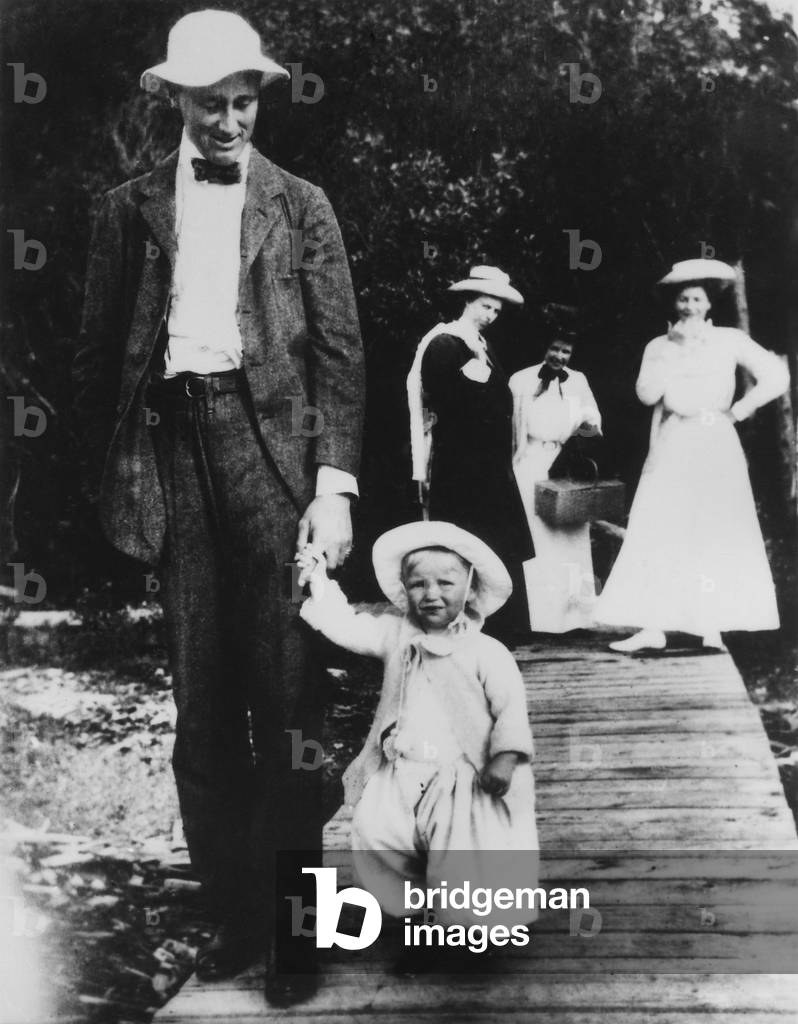 Franklin D. Roosevelt with his first child, Anna, at Campobello. 1908. Eleanor is with the group in the distance