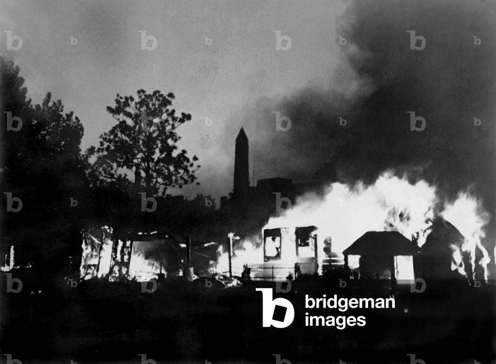 The Bonus Marcher's protest ended with a fire, set by U.S. Army, consuming the camp of Bonus Expeditionary Forces. The Washington Monument is in the background. July 29, 1932