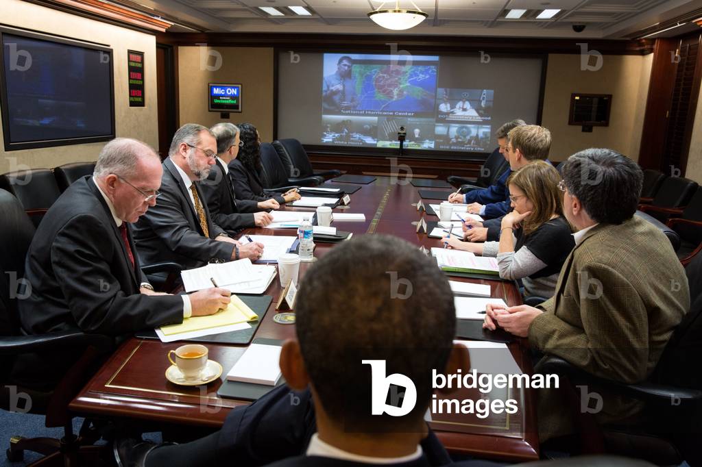 Situation Room of the White House, during Hurricane Sandy, Oct. 29, 2012. Attending, clockwise from President Obama: John Brennan; Richard Reed; Chuck Donnell; Asha Tribble; David Agnew; Press Secretary Jay Carney; Deputy Chief of Staff for Operations: Alyssa Mastromonaco; and Chief of Staff Jack Lew