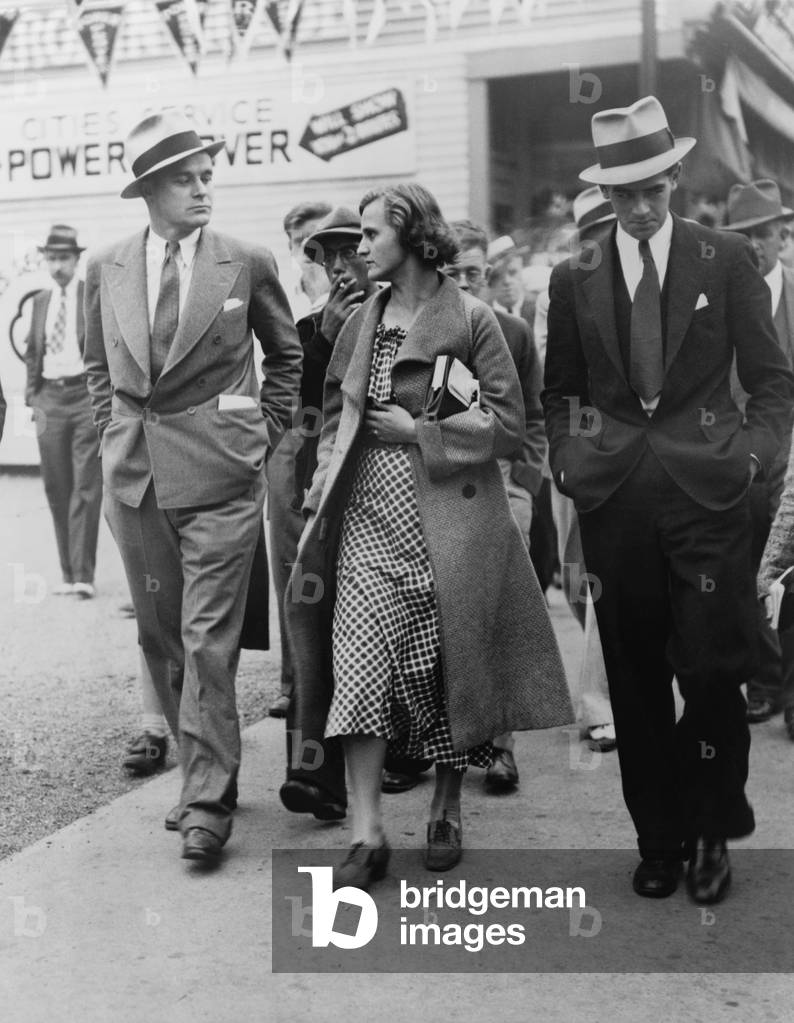 Ann Burlak (1911-2002), self-proclaimed communist revolutionary, leaving a striker's rally with reporters after she was refused permission to speak. Fall River, Massachusetts, 1934