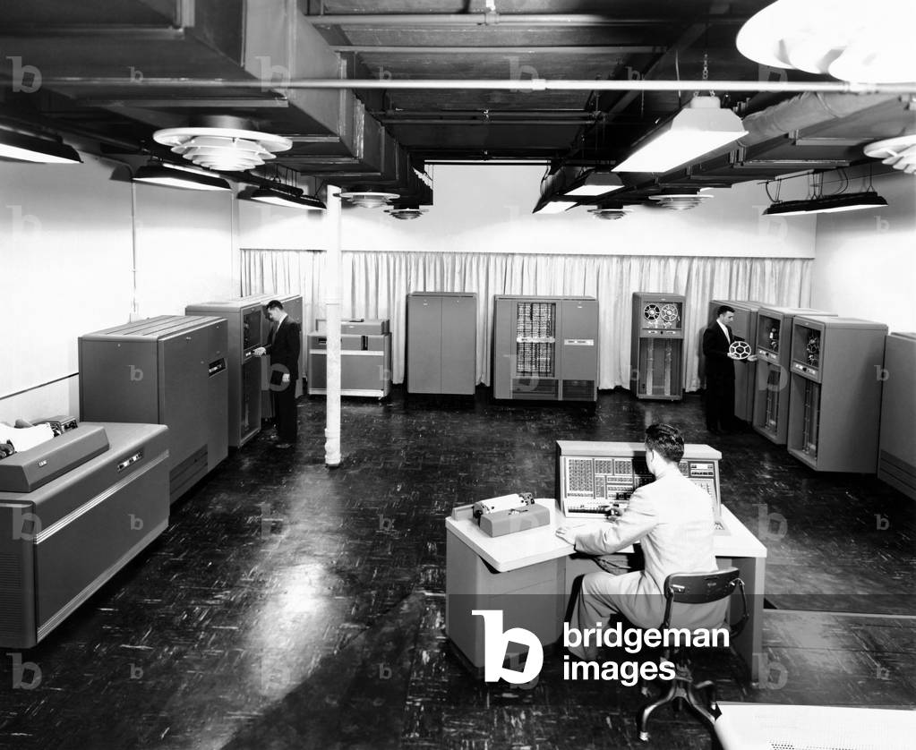 Partial view of the new IBM type '702' electronic data processing machine, a 'giant brain' designed for business. The '702' consists of a dozen or more electronically interconnected units. The '702' is operated from a central console. Dec. 10, 1954