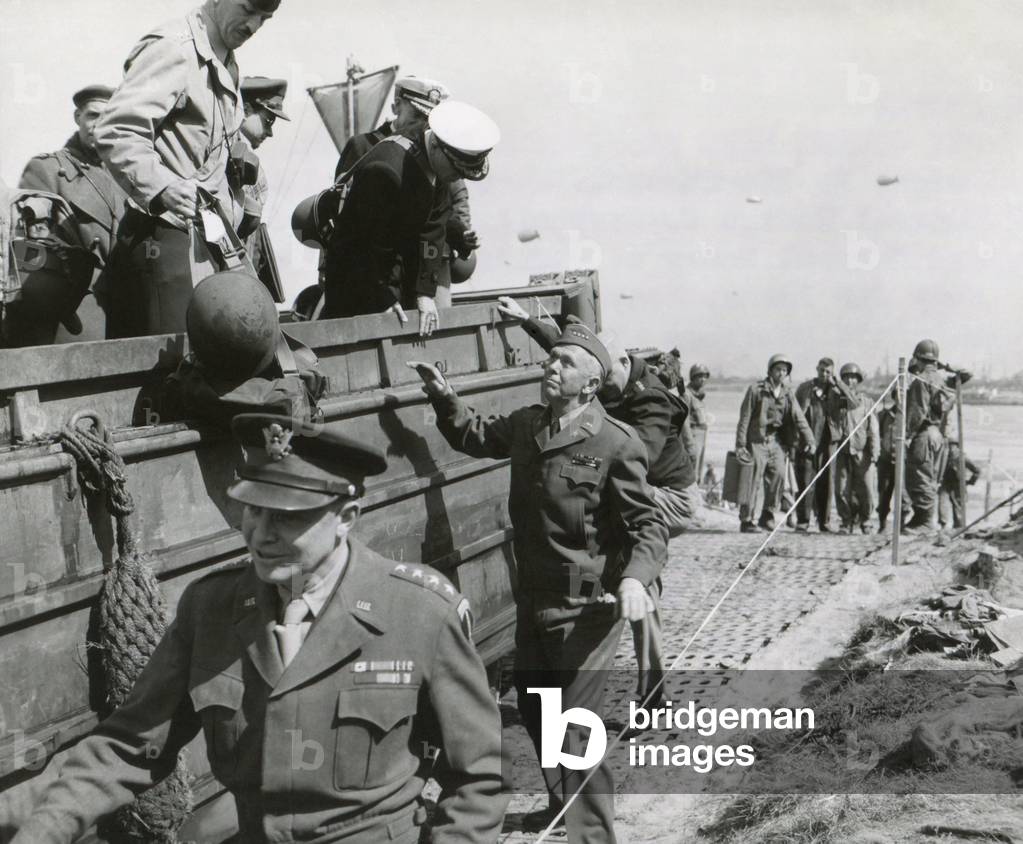 U.S. Chiefs make inspection in France a week after the D-Day invasion in Normandy. June 14, 1944. Walking beside vehicle: Eisenhower, Supreme Allied Commander; General George Marshall, Chief of Staff; and (obscured behind Marshall) Henry Arnold, Commanding General, Army Air Force. World War 2