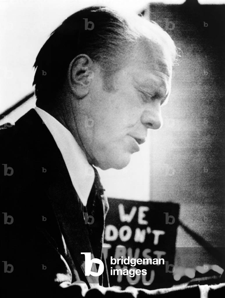 President Ford encounters an unfriendly sign, 'We Don't Trust You', which campaigning for President. Sept.9, 1976