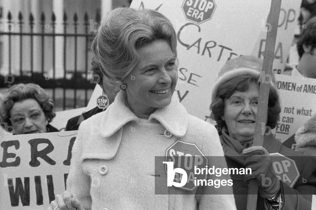 Conservative activist Phyllis Schafly wearing a 'Stop ERA' badge demonstrating with other women against the Equal Rights Amendment in front of the White House Washington D.C. Feb. 4 1977