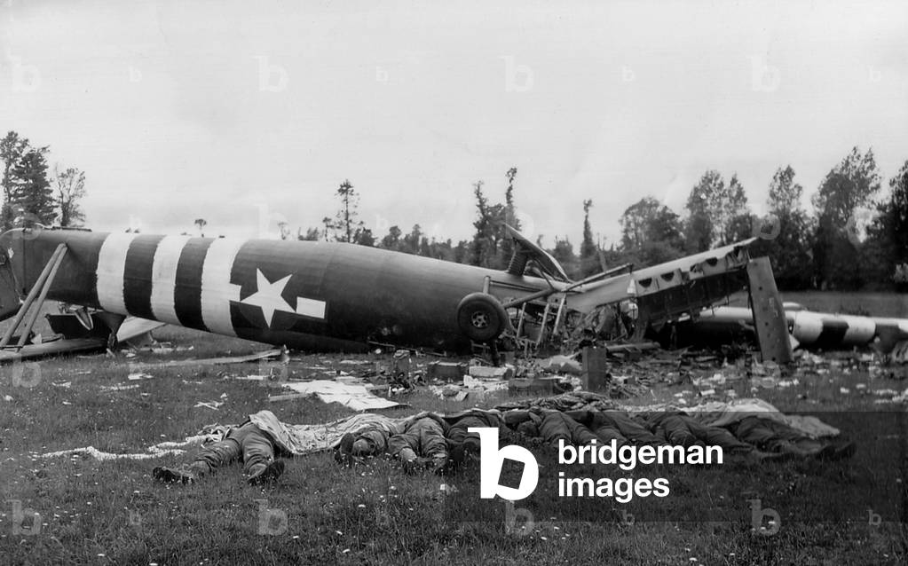 Eight dead U.S. paratroopers lie beside their destroyed Horsa glider in a Normandy pasture. They were among the 22,000 Allied Airborne soldiers that jumped behind the Normandy beaches to disrupt German counter attacks to D-Day invasions. June 6, 1944, World War 2
