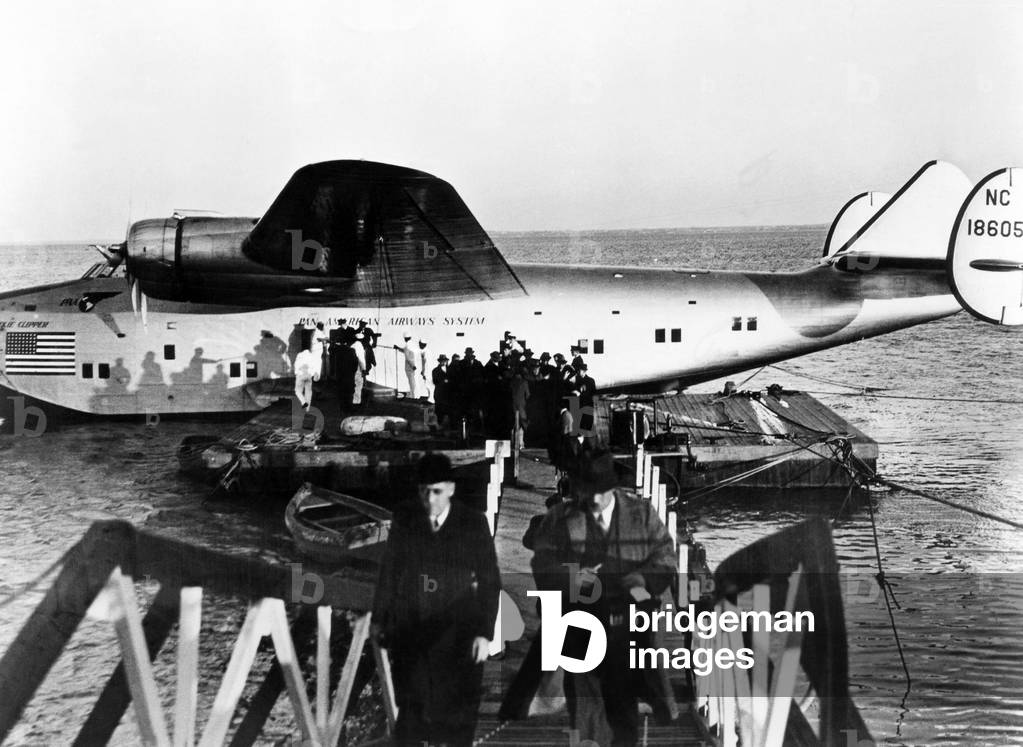 The first passengers to cross the Atlantic leave Pan American's Dixie Clipper airplane in Lisbon, Portugal. The plane took off from Port Washington, New York, 1939