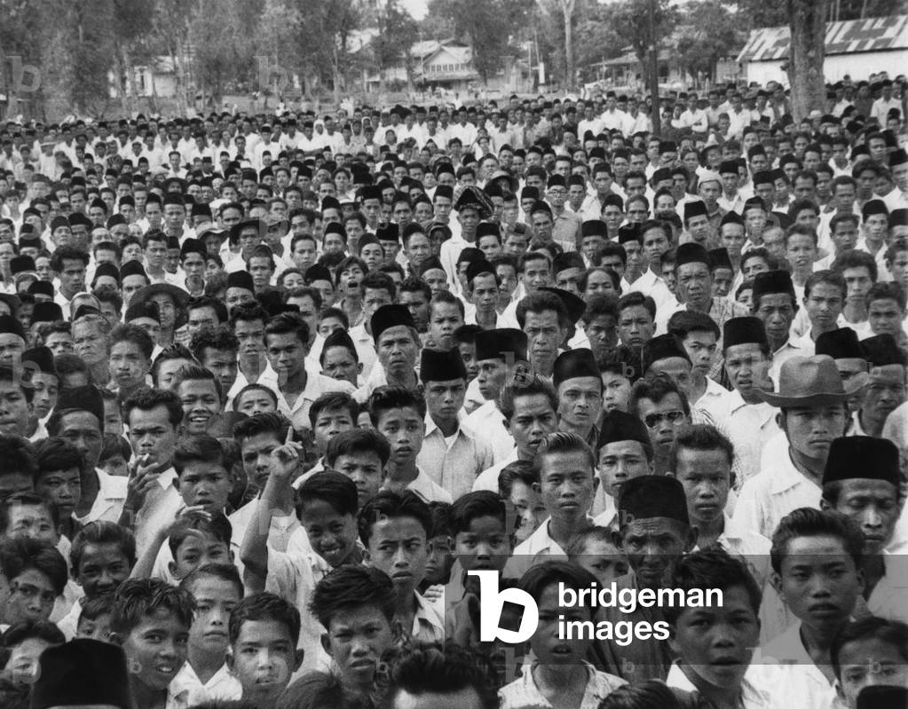 Indonesians in an anti-Sukarno rally in Batu Sankar, Sumatra. They protested President Sukarno's consolidation of dictatorial powers. 1958