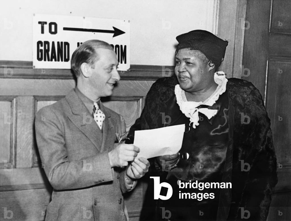 Faithful Mary, presenting a subpoena Ulster County Court. She will testify about the Peace Mission's rural 'Heavens' throughout the county. Formerly the Peace Mission's No. 1 Angel, she publically proclaimed herself the true mistress of Father Divine's earthly and spiritual domain when he was recently in police custody. Faithful Mary possesses the Peace Market Hotel at High Falls, N.Y, although Father Divine has tried to convert it into one of the communal residences that he calls 'Heavens'. -