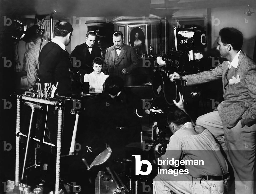 THE ADVENTURES OF SHERLOCK HOLMES, from left: director Alfred L. Werker (back to camera), Basil Rathbone, Ida Lupino, Nigel Bruce filming on set, 1939