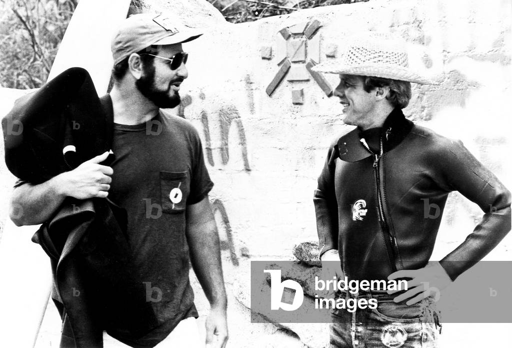 BIG WEDNESDAY, from left, director John Milius, screenwriter Dennis Aaberg, on location, 1978