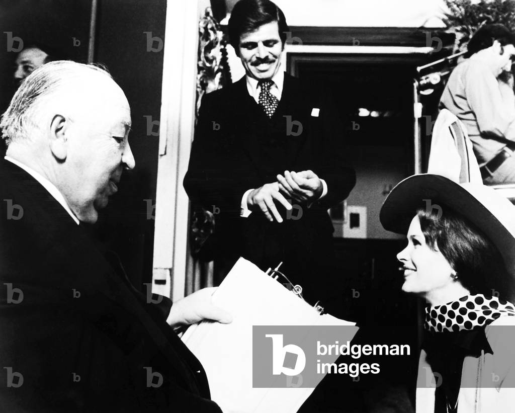 FAMILY PLOT, director Alfred Hitchcock (left) rehearses a scene with William Devane and Karen Black, on set, 1976