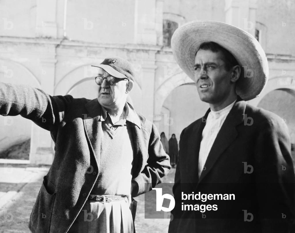 THE FUGITIVE, from left: director John Ford, Henry Fonda on set, 1947