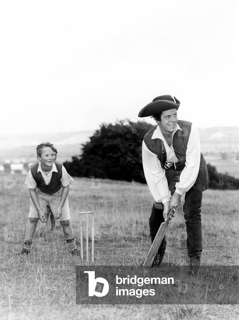 DICK TURPIN'S RIDE, Louis Hayward, on location  in the Chiltern Hills, plays cricket with local boy Morris Chapman, September 1950