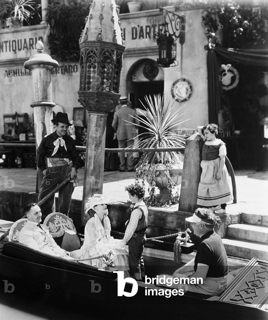 ANNA KARENINA, front from left: Fredric March, Greta Garbo, Freddie Bartholomew, director Clarence Brown on set, 1935