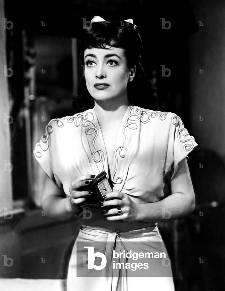 ABOVE SUSPICION, Joan Crawford, in a dress designed by Irene, 1943