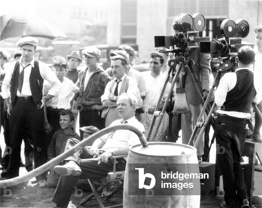 THE GREAT GATSBY, propman Lee Nagel (far left), assistant director Ray Lissner (cednter arms folded), director Herbert Brenon (sweated), on-set, 1926