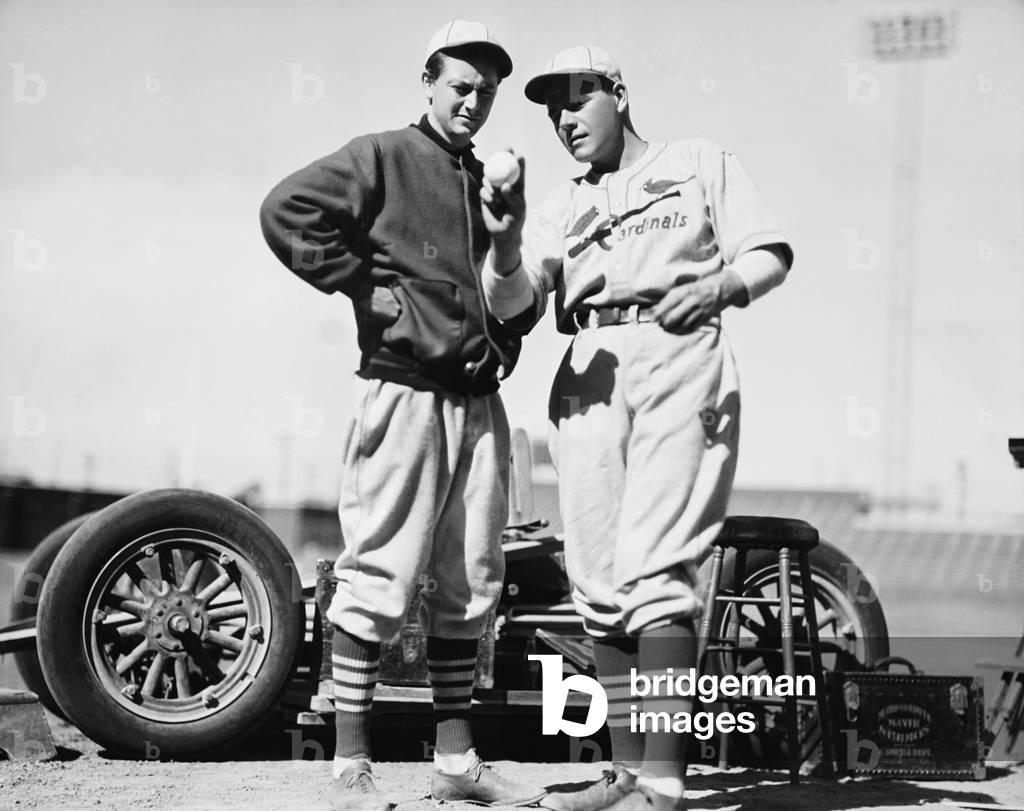 DEATH ON THE DIAMOND, former major leaguer Pat Flaherty (right) instructing Robert Young on how to pitch on set, 1934